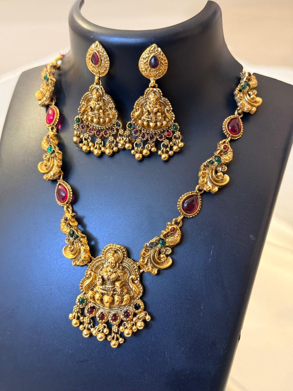 Ruby Stone With Lakshmi And Peacock Motif Necklace With Earrings