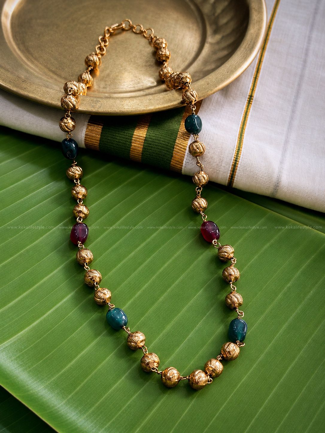 Gold toned beaded chain.