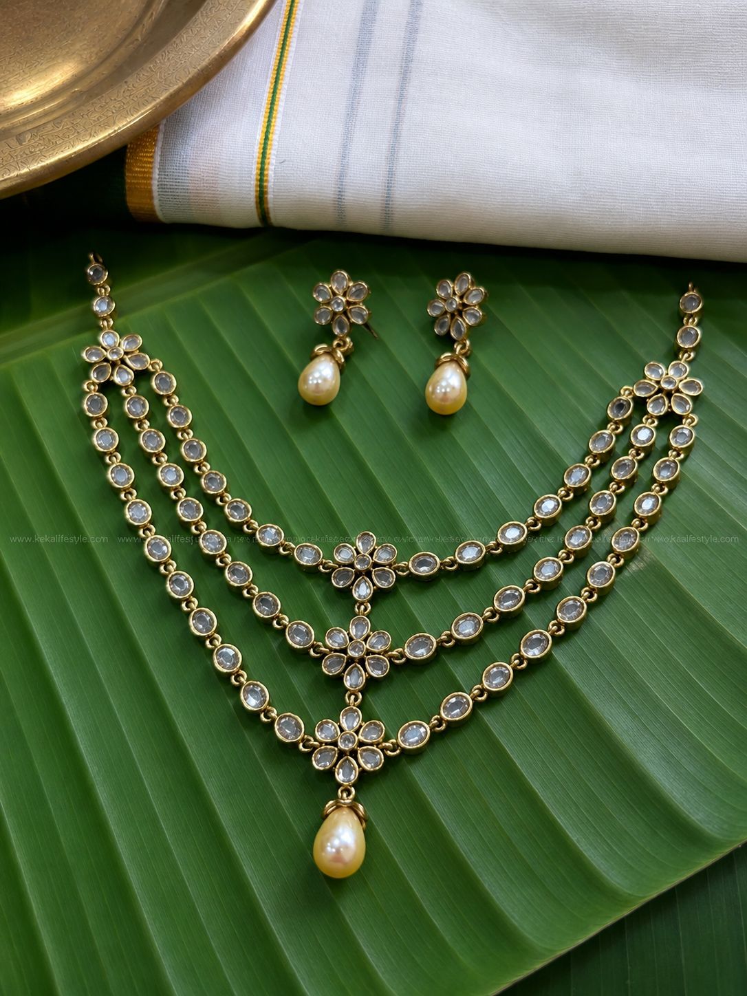 Triple layer white stone,flower motif necklace with earrings