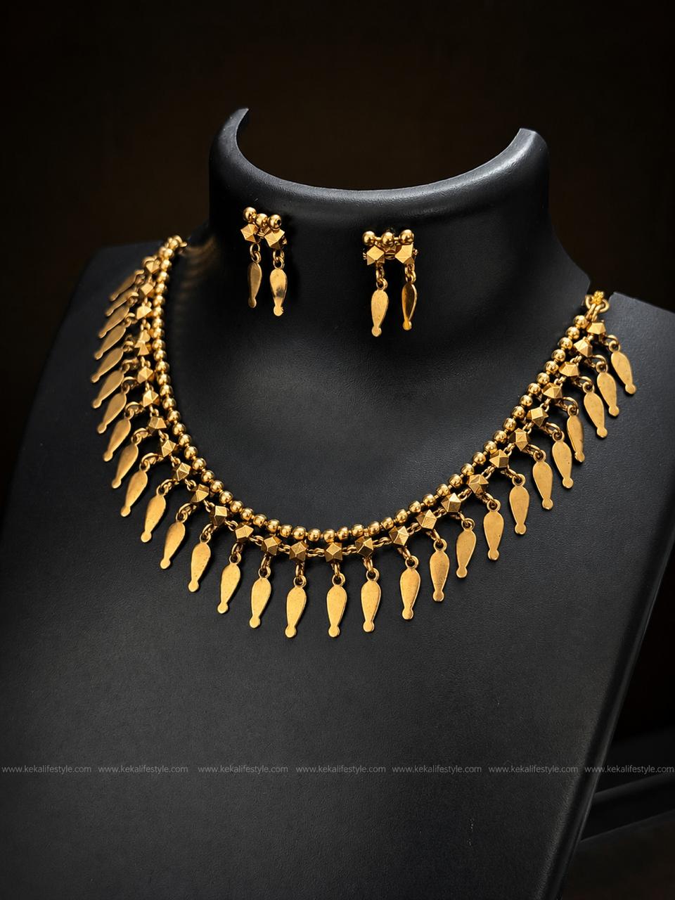 NGN0243 - Premium quality llakkathali design necklace with antique gold finish and elegant leaf danglings. Comes with matching earrings