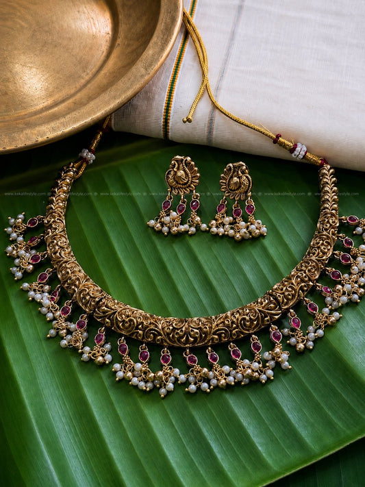 Indricate designed hasli with ruby and pearl drops necklace with earrings