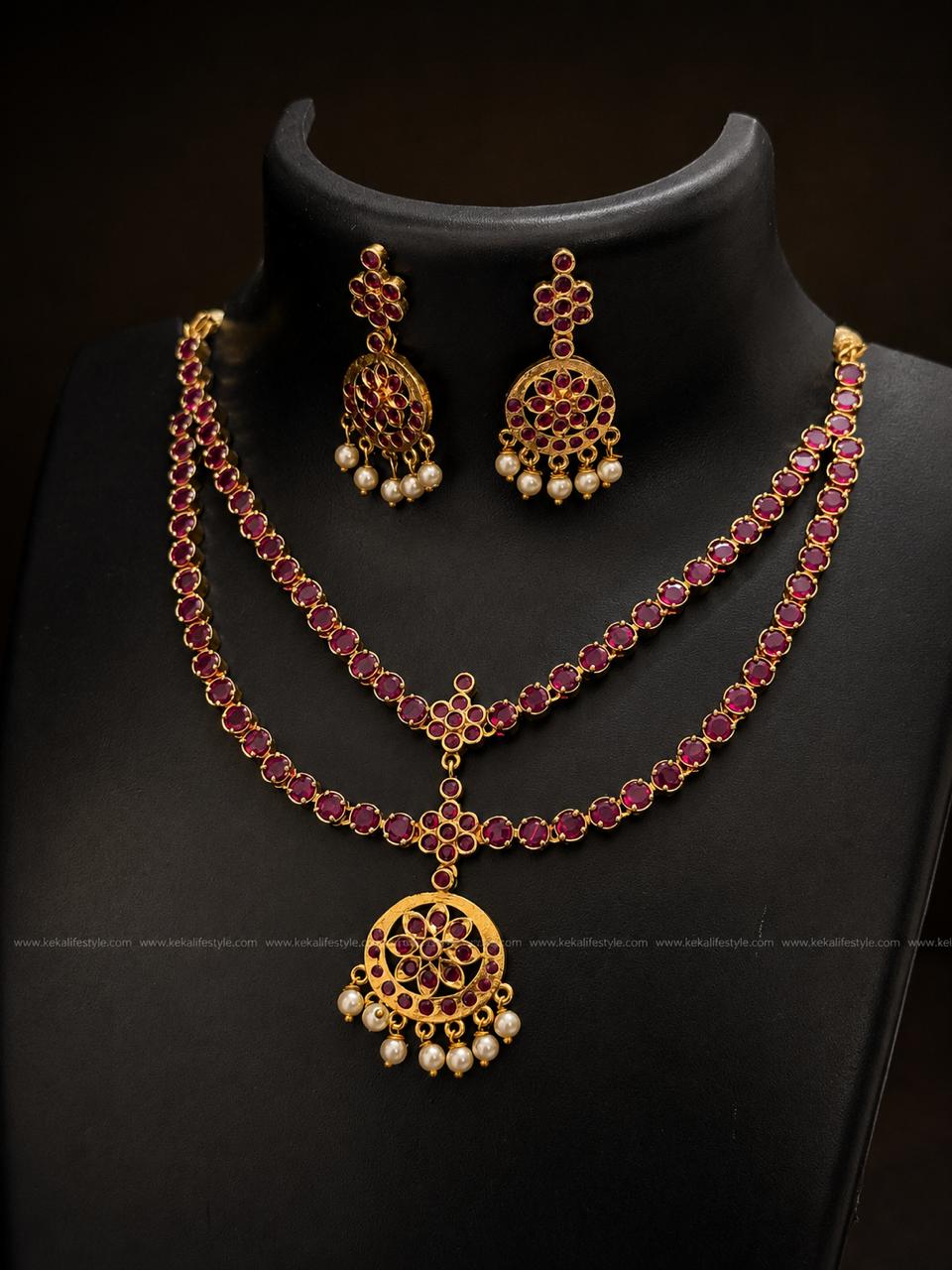 NGN0240 - Heritage-inspired ruby stone necklace featuring a double-layer attigai design, floral centrepiece and pearl hangings. Complete with matching earrings