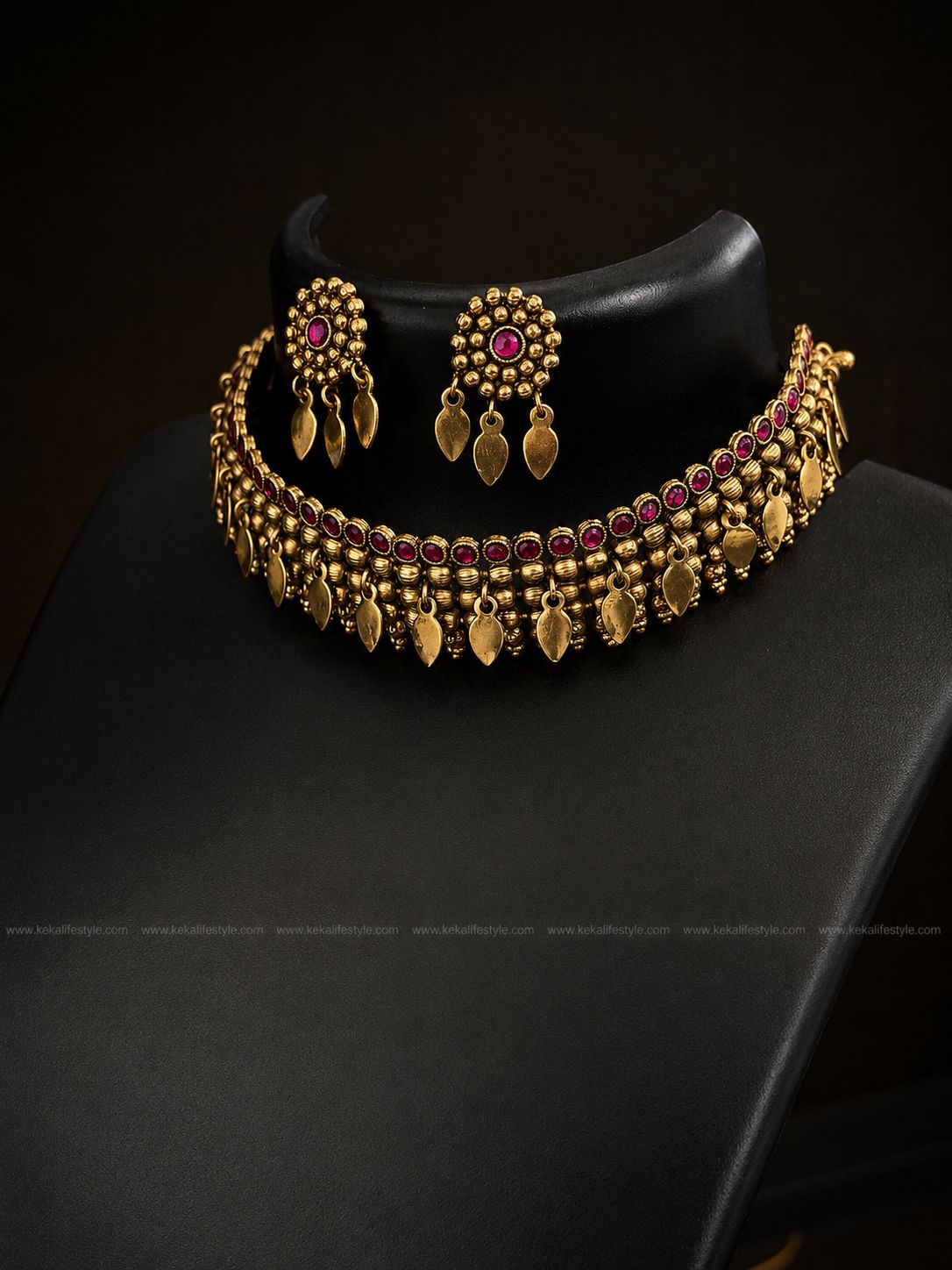 NGN0248 - Premium quality llakkathali design necklace with antique gold finish, ruby stone detailing and traditional leaf danglings. Comes with matching earrings