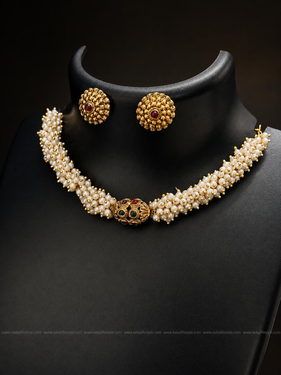 NGN0246 - Elegant handcrafted pearl necklace with a traditional ruby & emerald embellished centre motif. Complete set with matching earrings